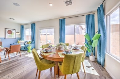 Dining area with wood finished floors and recessed lighting
Photo is representational only; actual home finishes may vary.