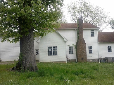 Back of property with a chimney