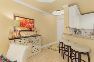 Kitchen featuring a breakfast bar area, crown mold