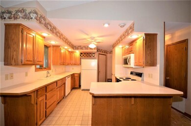 Spacious Kitchen with ample counter and cabinet space. The door to the back goes to the garage.