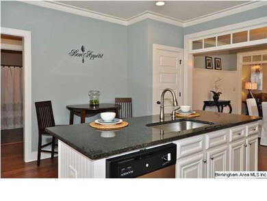 Kitchen also features an island with breakfast bar