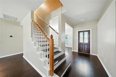 This entryway features a modern staircase with woo