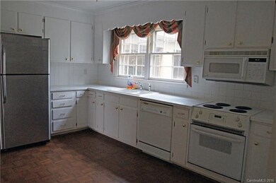 Kitchen has plenty of cabinets and is spacious eno