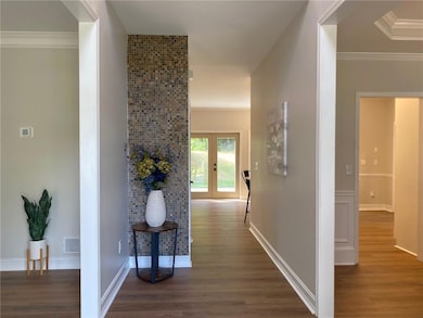 Corridor featuring wood finished floors, french do