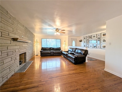 Family room features a full wall, stone, gas firep