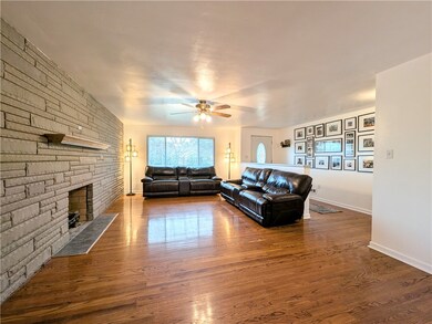 Family room features a full wall, stone, gas firep