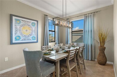 Tiled dining area featuring crown molding, chandel