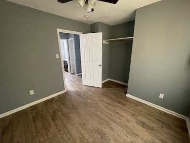 Unfurnished bedroom with wood-type flooring, a clo