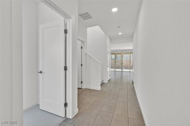Hallway featuring light tile patterned floors, rec