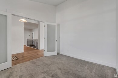 Carpeted empty room with baseboards