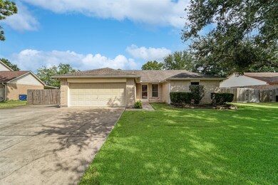 The front elevation of this single-story bungalow is constructed of a creamy-colored brick trimmed with long-lasting Hardie Plank finishes. All of this is complemented by established landscaping and a sprawling shade tree.