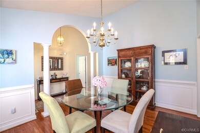 Hardwood floored dining room featuring a chandelie