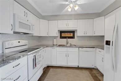 Kitchen featuring sink, crown molding, white appli