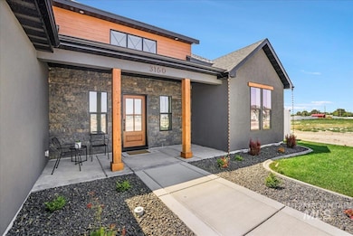 Entrance to property featuring stone siding and stucco siding