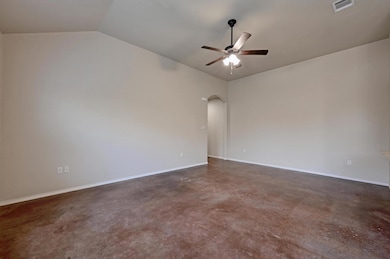 Spare room with ceiling fan, arched walkways, vau