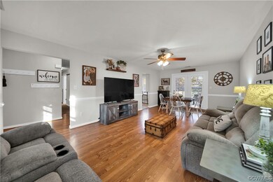 Living room with light wood-type flooring and ceil