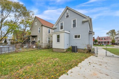 Back of property featuring a fenced backyard and a gate