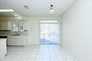 Unfurnished dining area featuring ornamental molding, light tile patterned floors, and plenty of natural light