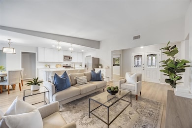 Living room featuring light wood-style flooring a