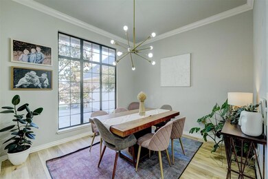 Dining space featuring a notable chandelier, hardw