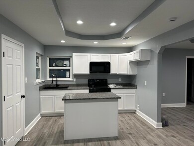 front facing kitchen w clean living room
