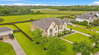 It showcases a large, well-maintained lawn, and fe