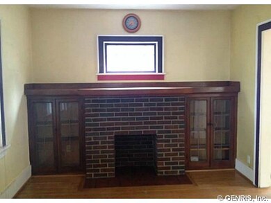 Living Room. Lovely ornamental fireplace flanked b