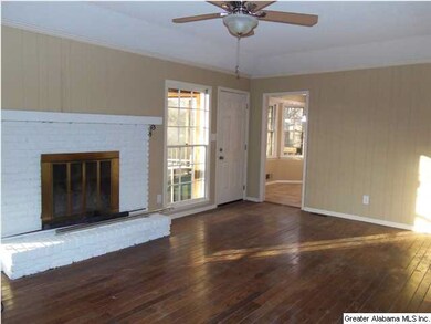 Family room features hardwoods and wood burning fi