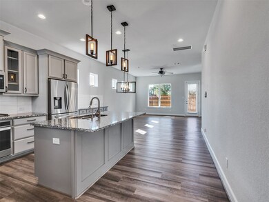 Large kitchen island and stainless steel appliances