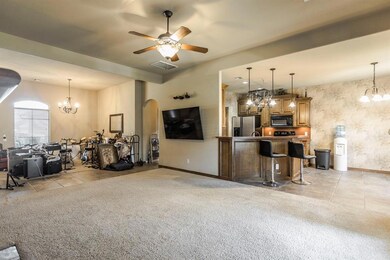 Living room with ceiling fan with notable chandeli