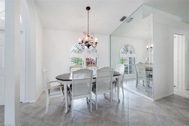 Dining space with a chandelier, healthy amount of natural light, and baseboards