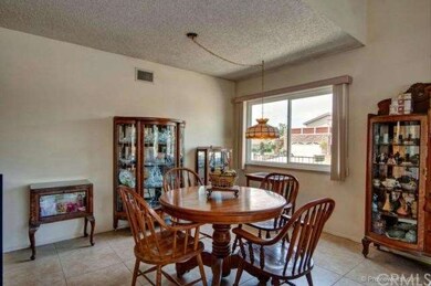 Formal Dining Area Adjacent To Living Room With Another Window To Provide Additional Natural Light.