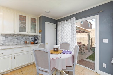Dining space with light tile patterned floors and