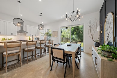 Dining area featuring concrete floors, recessed l