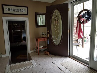 Ceramic entry with access to home, garage a back p