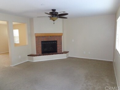 family room w/fireplace and ceiling fan