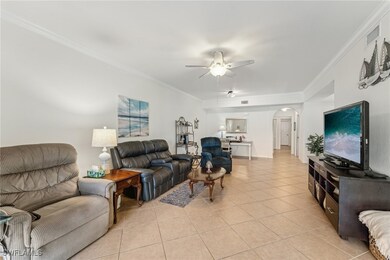 Living room with light tile patterned floors, orna