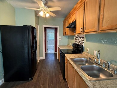 Kitchen featuring dark wood-type flooring, ceiling