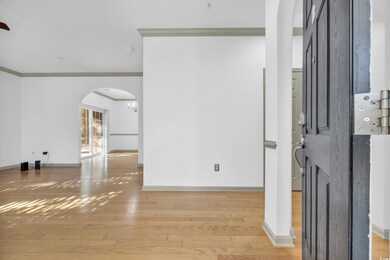 Empty room with crown molding and light hardwood /