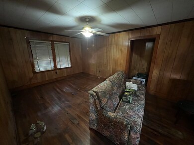 Interior space featuring wooden walls, ceiling fan