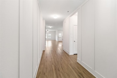 Hall with baseboards and wood finished floors