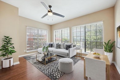 Living room featuring ceiling fan and wood finish