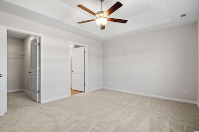 Unfurnished bedroom featuring carpet floors, baseb