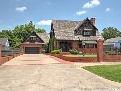 Expansive drive, beautiful brick and ironwork fenc