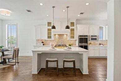 Kitchen with double oven, a center island with si