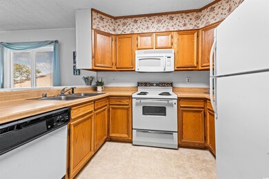 Kitchen with brown cabinets, light tile patterned 