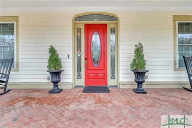 Handsome bricked entryway & stately door w/ bevele