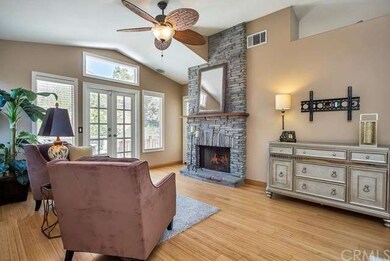 Great Room with Stone Fireplace & French doors lea