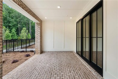 A sliding glass door provides seamless access to the interior, allowing natural light to flood in while offering convenient indoor-outdoor flow.