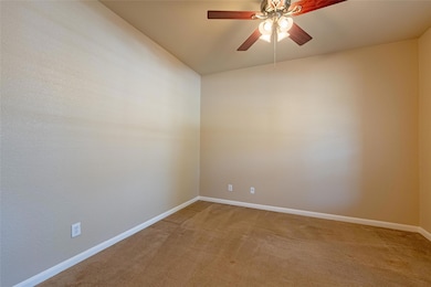 Unfurnished room with light carpet, a ceiling fan
